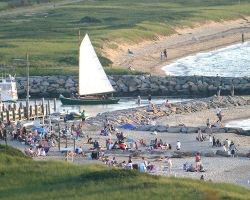 Beachgoers, boaters, and fishermen at Lake Tashmoo Beach in Martha's Vineyard, Massachusetts